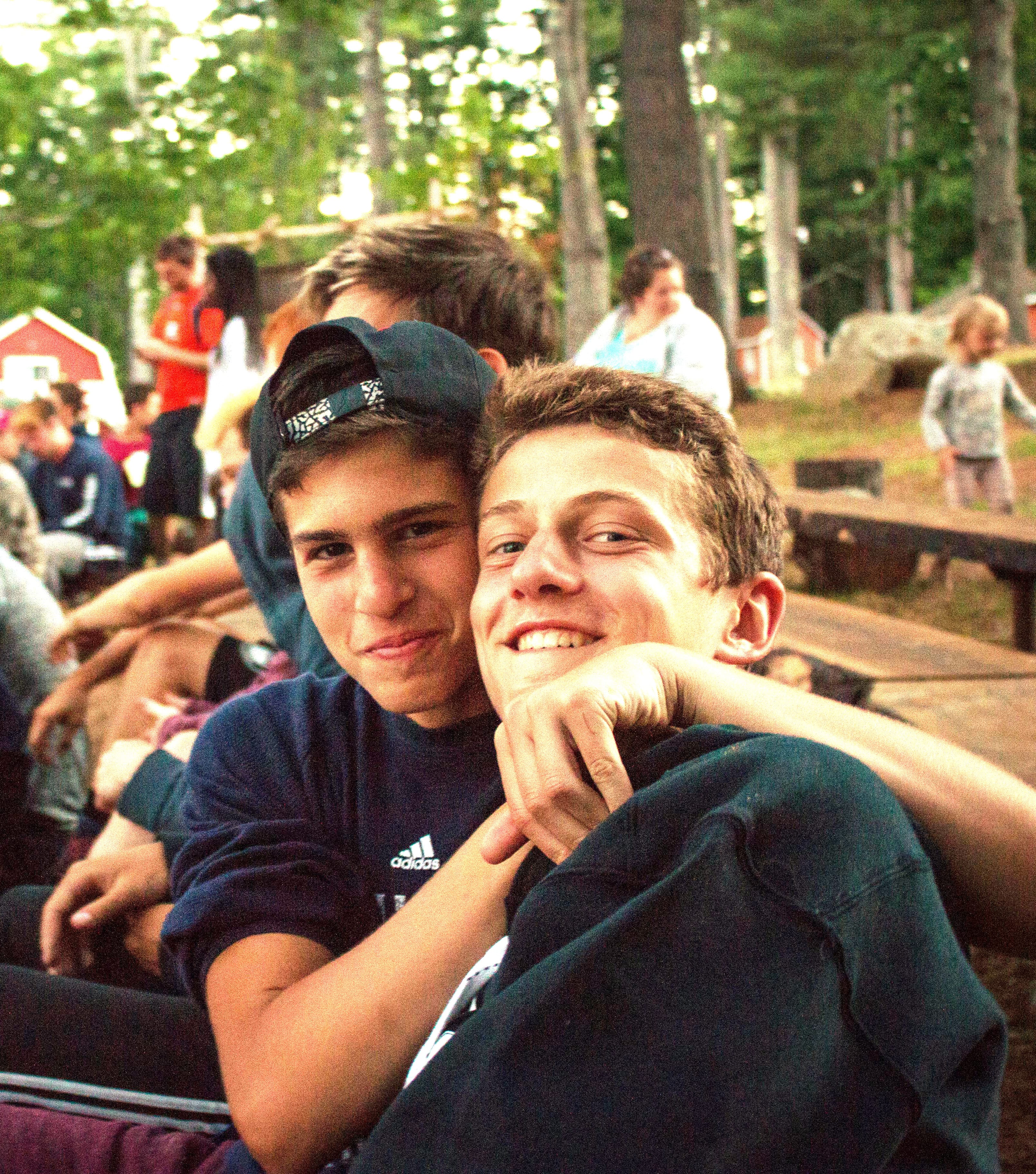 older boy brotherhood campfire hugs